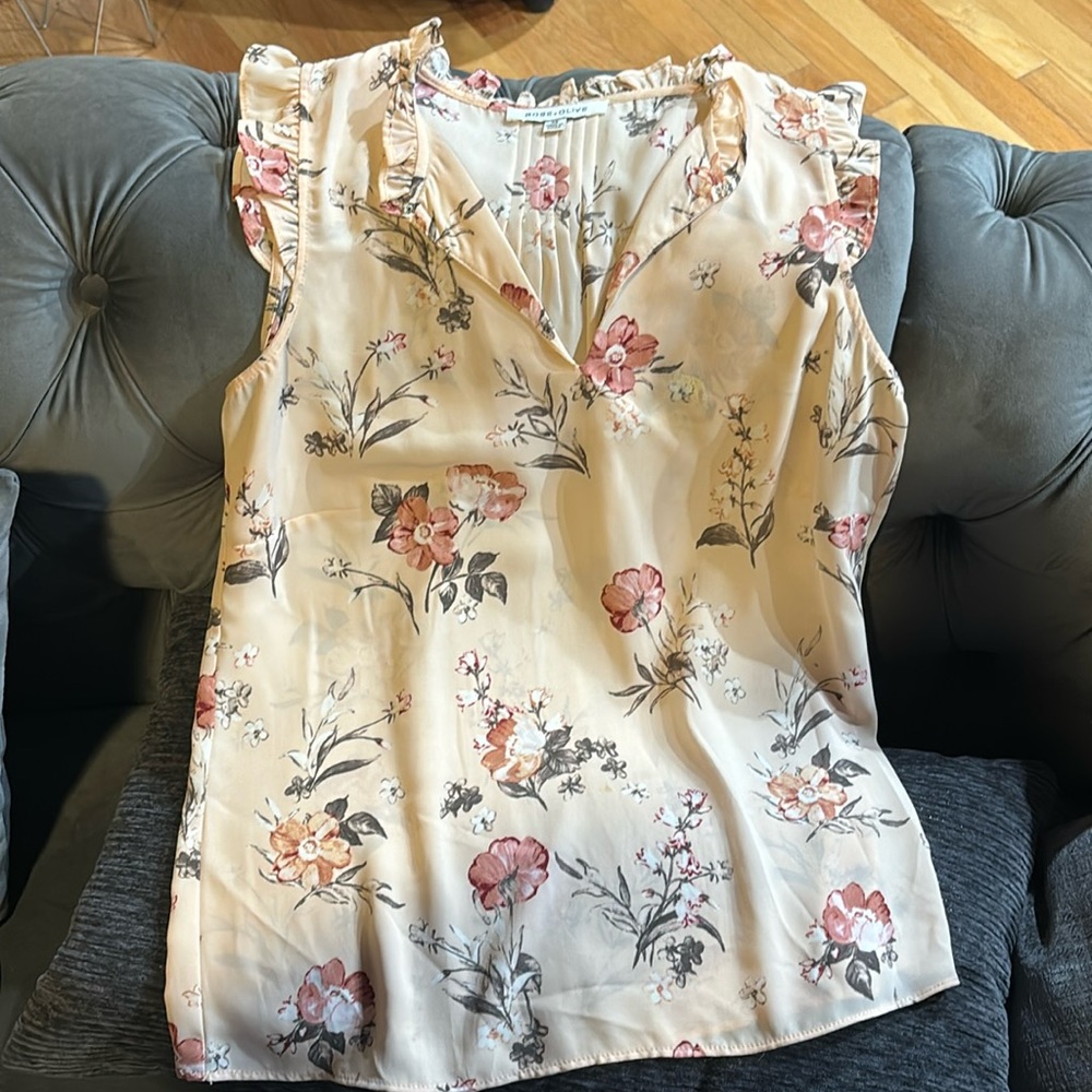 peach floral sleeveless top shown with pants for an idea of what i put together
